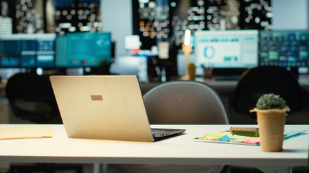 Modern business workspace glows with forecasting metrics and graphs. Corporate empty space equipped with technology and computers reflects administration of enterprise objectives.の写真素材