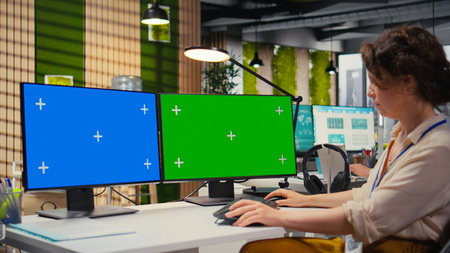 Focused office administrator using data for forecast with a green screen, building a new development strategy to expand the business and boost performance reports. Professional objectives.の写真素材