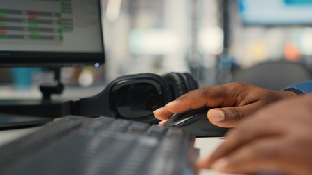 Close up of black employee leverages report writing for business development and monthly performance results, resources and insights to ensure strategic goals achievement. Camera B.の写真素材