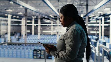 Data center software developer adjusts system settings to improve AI rigs processing speed. Server hub worker uses tablet, upgrading hardware to support artificial intelligence workloads, camera Bの写真素材