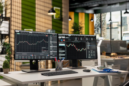 Computer monitors in forex company office displaying stock exchange price charts. PC screens showing with stock market financial software trading platform interface in prop firm workspaceの写真素材