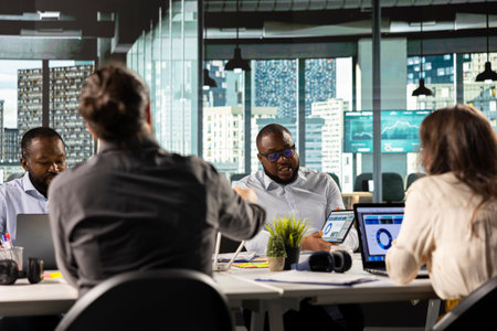 Corporate employees reviewing documentation and performance reports. Colleagues in a professional...