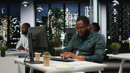 African american office staff leverages analytics and report writing for development and monthly...