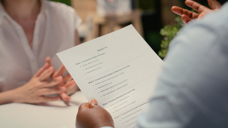 Close up of applicant reviewing monthly perks and medical subscription options, meeting with a recruiter to go over the benefits package for work contract. Reaching an agreement.の写真素材