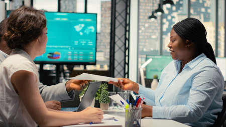Female applicant and hiring staff greeting each other in interview meeting, asking questions and discussing about career opportunity for onboarding into the department. Head hunting.の写真素材