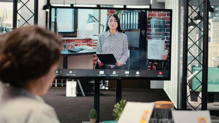 Diverse HR staff hosting a virtual meeting to interview a candidate via web video conference,...