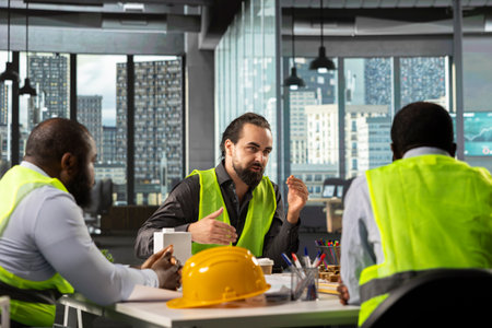 Developers and architects working on real estate investment plan. Business team analyzes property data, housing blueprints and market trends to optimize land acquisition and projects.の写真素材