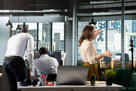 Business coworkers in modern office space sharing insights and reports, work team focuses on data visualization for efficient resource allocation. Successful company administration.の写真素材