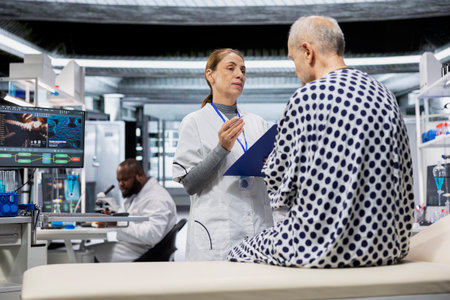 Woman medical researcher consulting a senior patient in lab for RD strategy, working in laboratory for new drug testing and monitoring vitals. Medic at modern institute reviews side effects.の写真素材