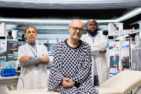 Portrait of medics team and old patient posing in research laboratory, working in modern drug testing for innovation and breakthrough in biomedicine. Senior man and doctors.の写真素材
