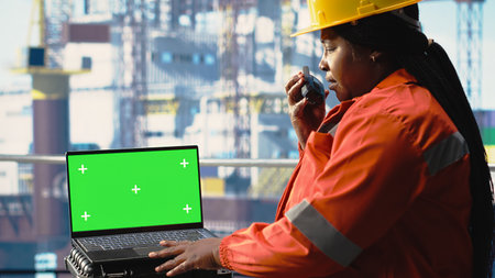 Isolated screen laptop used by energy production company worker to determine optimal drilling rig...