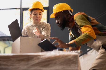 Multiethnic colleagues preparing cargo goods for delivery in a depot, working with inventory control...