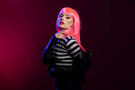 Confident model with pink bob hairstyle flaunts bold attitude during fashion forward shoot with...
