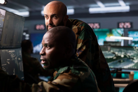 Army officers use reconnaissance gear to do threat monitoring and target recognition. Military specialists in headquarters employing modern warfare intelligence to help troops defeat opponentsの写真素材