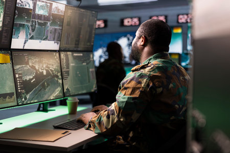 Soldier working in base of operations housing operational missile defense system designed to intercept ballistic rockets. Intelligence service professional using radar systemsの写真素材