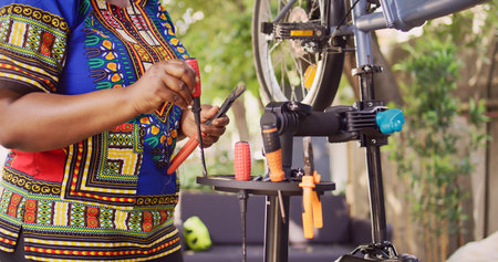 Sports-loving african american female arranging an assortment of professional equipments for bike...