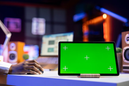 Close up of isolated screen tablet used by worker in home office analyzing data charts, identifying trends. Freelancer using chroma key device, compiling analytical reports, processing dataの写真素材