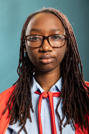Closeup of african american woman with glasses looking directly at camera, exuding confidence....
