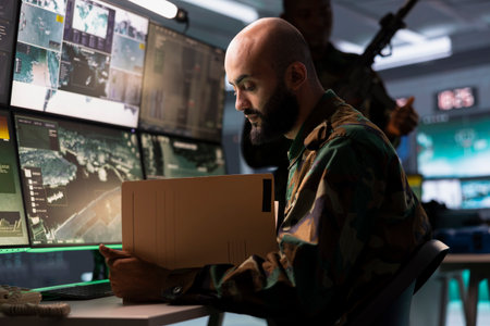 Military officer reviews battlefield information after conducting airspace surveillance, supporting...