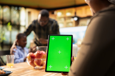 Chroma key in a vertical position with family serving breakfast surrounded by good food, smiling as they eat with kids. Reflecting joy, connection and the warmth of a cozy morning routine.の写真素材