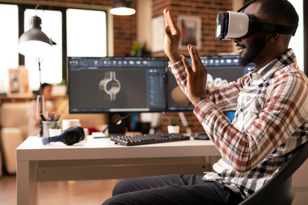 Focused black designer using virtual reality headset to develop digital building models for construction projects. Advanced immersive technology supporting interactive design review.の写真素材