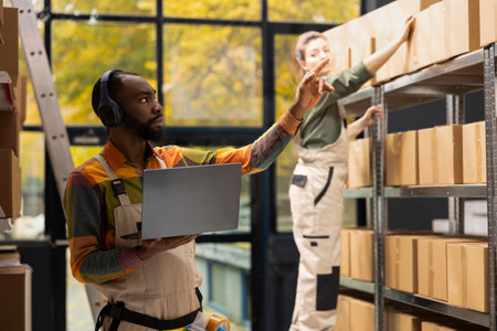 E-shop employee listens to favorite music on headset and counting packages, overseeing quality...