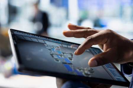 Male industrial expert handling the assembling process on tablet, working on clean sustainable energy by creating solar panel factory. Engineering innovation for production flow. Close up.の写真素材