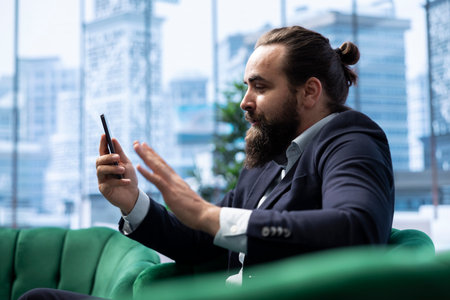 Skilled empowered male CEO negotiating with shareholders on online call, asking for more funds to sustain an expansion project. Businessman director driven for success, leadership skills.の写真素材