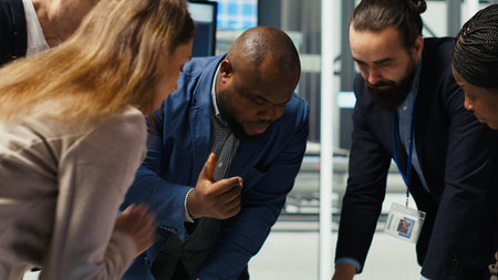 Factory engineers study detailed schematics of solar panel assembly lines, refining production layouts using tablet. Industrial plant experts outlining configurations for new prototypes, camera Bの写真素材