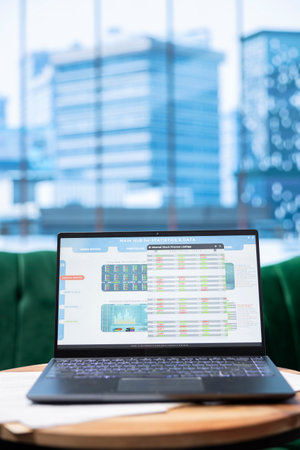 Empty modern corporate stylish office space designed for a CEO or leader, running analytics and reports on laptop screen. Urban global enterprise workspace, executive power and success.の写真素材