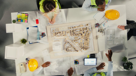 Top down view of colleagues in architecture working together on project design and development. The...