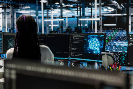 Female technician in server hub using PC to review equipment rigs diagnostics. Employee in data...