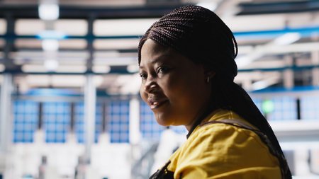 Solar panel manufacturing plant researcher taking notes on tablet, developing new solar energy systems prototypes. Engineer inspecting new photovoltaics materials, writing down info. Camera A.の写真素材