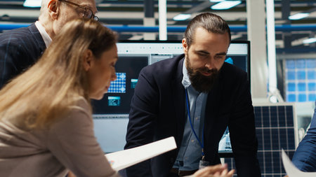 Industrial plant managers and investors analyze technical production data on paperwork documents....