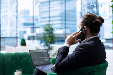 Male entrepreneur holds a decision making call with senior consultant, strategizing about investment and settling on a stock strategy to double the firm income. Corporate expansion.の写真素材