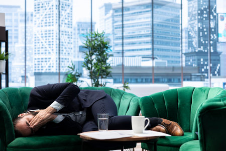 Depressed worried entrepreneur struggles with business failure and bankruptcy, feeling overwhelmed by the financial crisis and the downfall of his company budget. Stock market crash.の写真素材