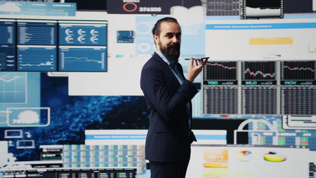 Executive chief uses telephone call to coordinate big data analysis and economic forecasting. Sharing infographics on dashboard and modern metrics to guide company performance. Camera B.の写真素材