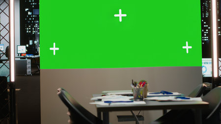 Empty boardroom with a digital copy space projection for a late night session focused on growth strategy, report analysis and multinational project alignment. High tech workspace.の写真素材