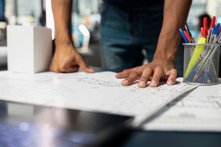 Middle eastern property contractor studying blueprints design for a future residential building project, architectural plans for a new housing initiative focused on innovation and market demand.の写真素材