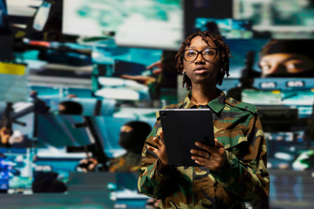 Soldier overseeing command center housing operational missile defense system designed to intercept ballistic missiles. Woman in armed forces headquarters used for tracking rockets using radar systemsの写真素材