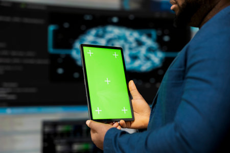 Black tech savvy programmer uses chroma key screen from innovation hub, working on digital transformation with software engineering and data science. Cybersecurity and automation.の写真素材