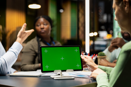 Professionals group meeting for a corporate brief with copy space screen after hours, aligning objectives and targets for company development. Late at night presentation agenda.の写真素材