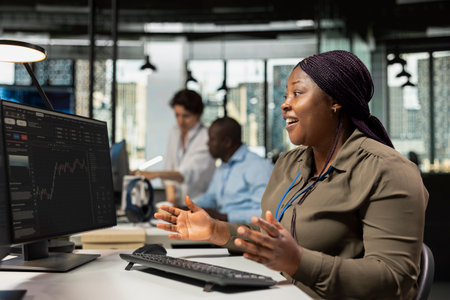 Cheerful AI startup CTO surprised by profits made from stock market trading, looking at graphs. Venture company female entrepreneur excited after securing funding from angel investorsの写真素材