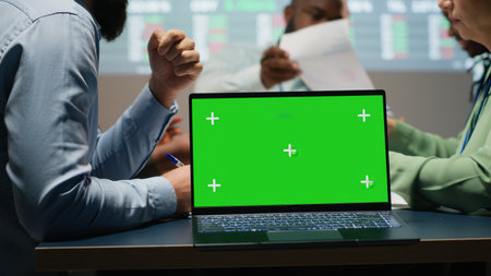 Corporate staff participate in late advisory board session with mockup, planning strategy and setting goals for project agenda. Experts reviewing updates with partners for success. Camera B.の写真素材