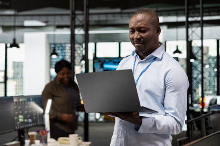 IT specialist in office automating repetitive business workflows using artificial intelligence tech on laptop. Engineer developer refining deep learning computational models with notebookの写真素材