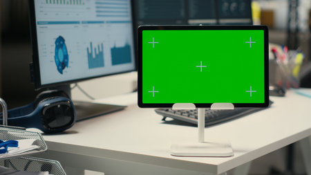 Empty office environment showcases tech tools of green screen and resources essential for business planning, performance analysis and the development of insights for innovation.の写真素材
