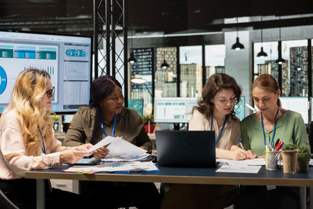 Diverse coworkers team form a powerful startup discuss business strategy, analyzing performance data...