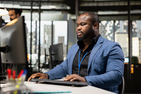 African american office worker developing a new business vision for growth, reviewing analytics and data insights to forecast performance. Aligning objectives for successful management.の写真素材