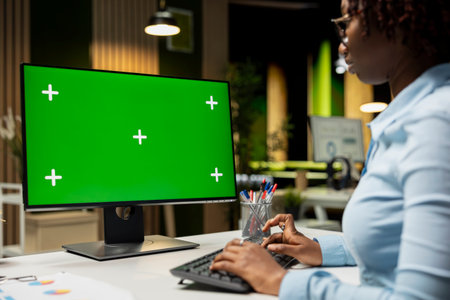 Green screen on computer monitor with black general director ensuring success, working in office...
