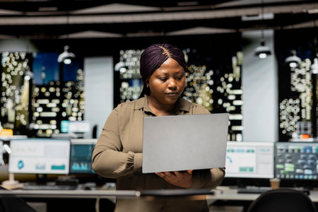 African american analyst reading emails and managing administrative tasks, documenting updates for a...